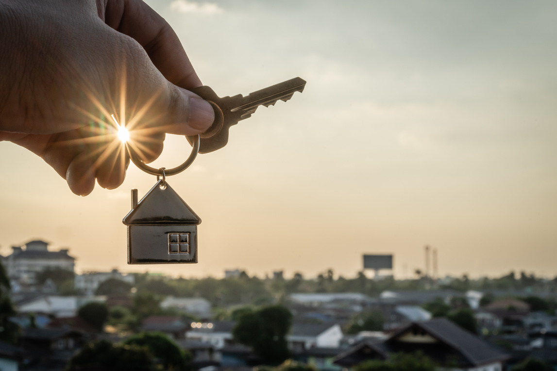 House model and key in home insurance broker agent  hand or in salesman person. Real estate agent offer house, property insurance and security, affordable housing concepts